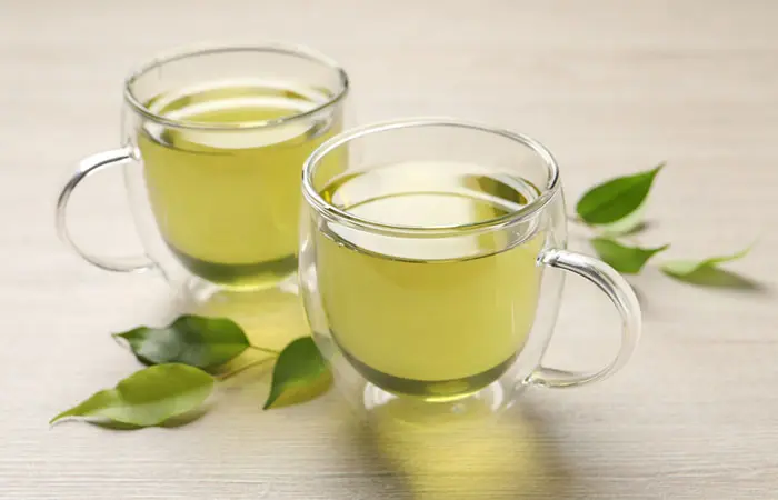 Green tea in cups with leaves