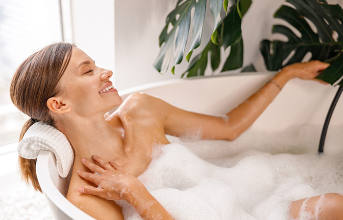 Woman avoiding washing her hair in a bath tub