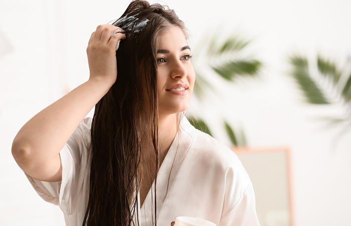 Woman using hair mask containing macadamia oil