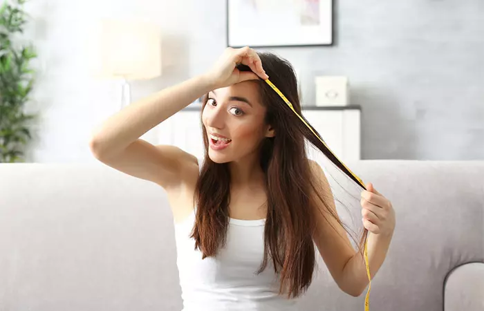 Woman experiencing hair growth as a result of high-frequency hair treatment