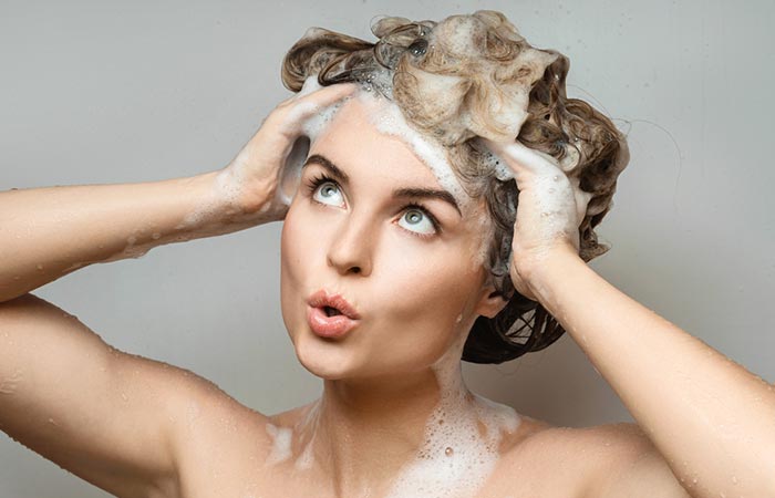 Woman wondering how long she can leave purple shampoo on her head