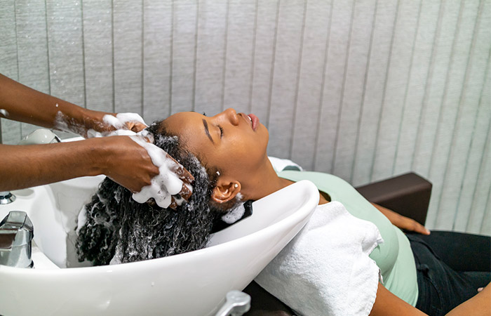 Woman getting her afro hair washed