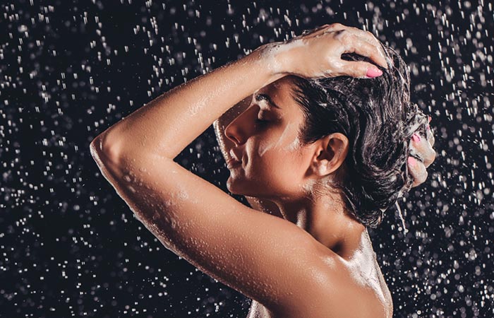 Woman washing hair with only water and not using shampoo