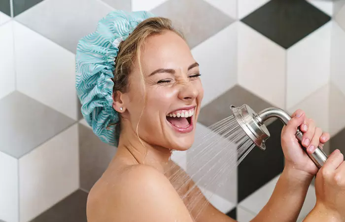 Woman enjoying hot water bath with a shower cap