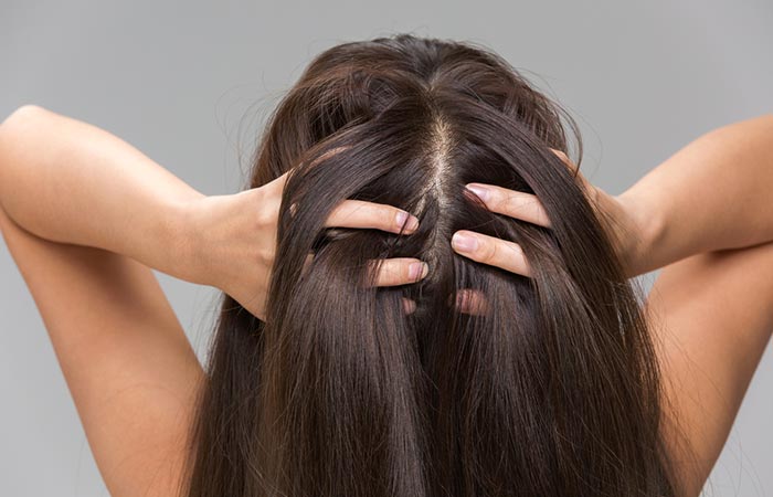 Woman massaging her scalp before shampooing