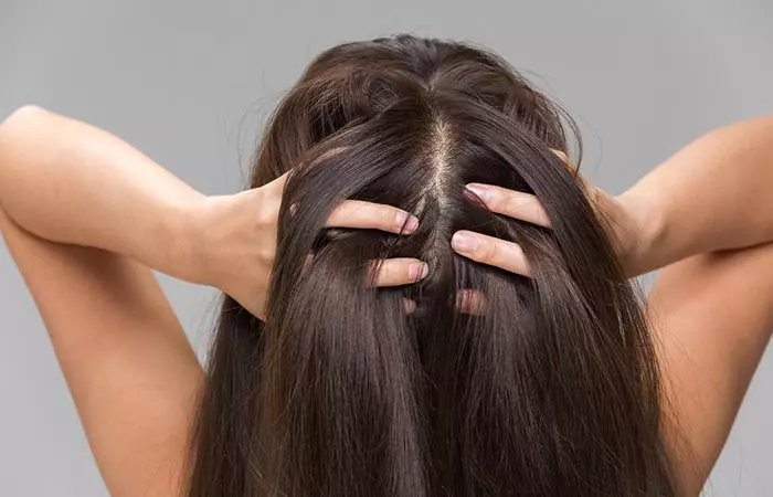 Woman massaging her scalp before shampooing