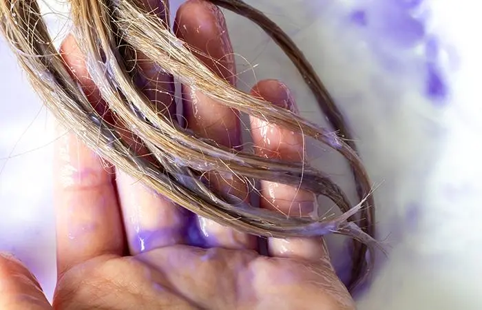 Purple shampoo on hair strands