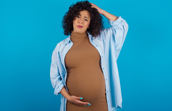 Pregnant woman wondering if it is safe to perm her hair during pregnancy.