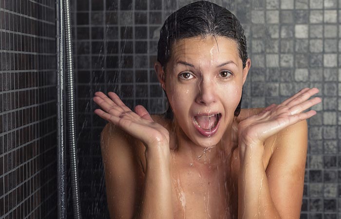 Woman using cold water for hair wash