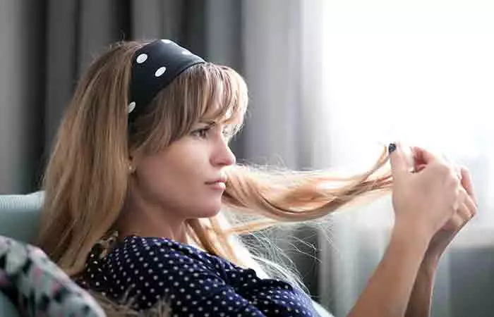 Woman checking her hair after bleaching