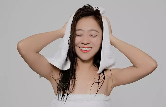 Woman towel drying her hair
