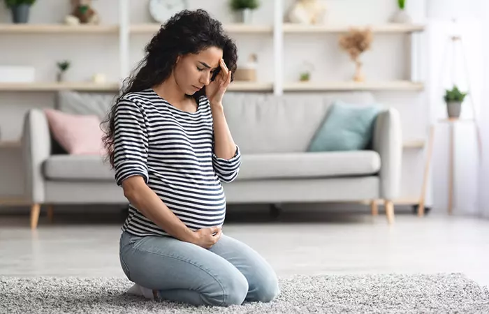 Pregnant woman experiencing migraines due to side effects of the products used in perming.