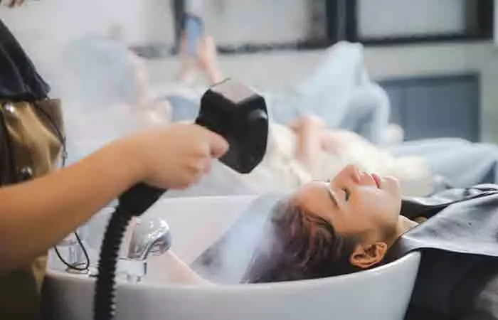 Woman getting her hair steamed at a salon