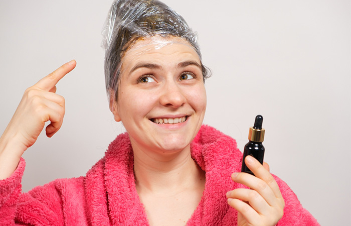 Woman using olive oil and plastic wrap to kill head lice