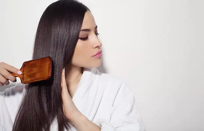 Woman brushing dry hair correctly