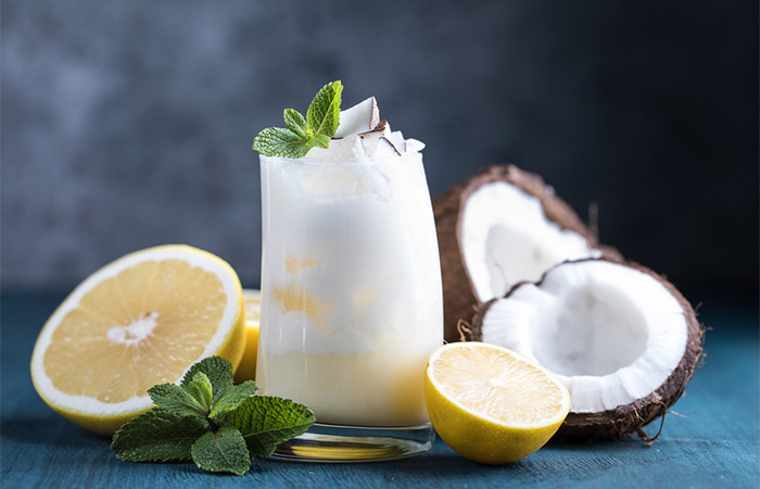 A glass of coconut milk and lemons.