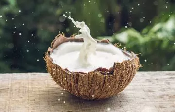 Coconut milk splashing in the coconut.