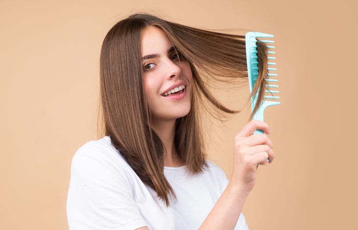 Woman combing hair with wide-toothed comb