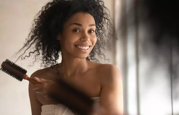 Woman detangling her curly hair