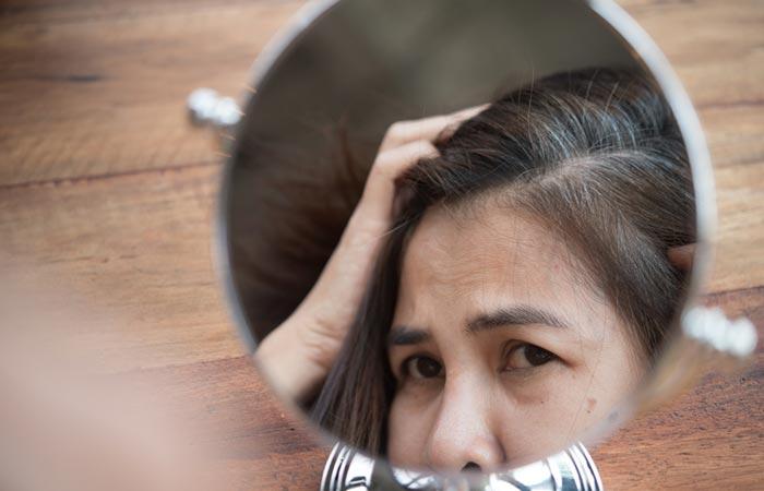 Woman looking at premature graying to use coconut oil and lemon juice