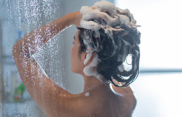Woman using a clarifying shampoo one day before coloring her hair