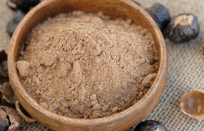 A bowl of reetha powder for a multani mitti face pack for oily hair