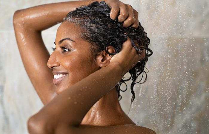 Woman washing her curly hair with a gentle shampoo