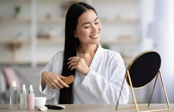 Woman combing her healthy hair