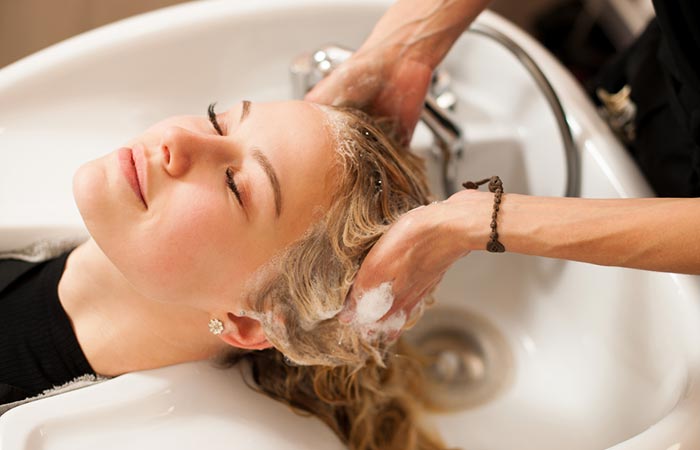 Woman enjoying a hair spa treatment done by a salon professional