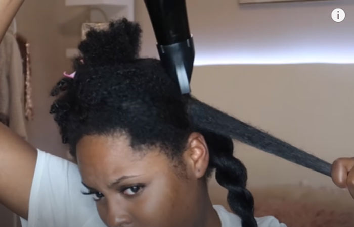 Twist this section and start blow drying another section of your hair.