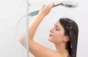 Woman using filtered water to rinse hair