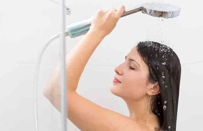 Woman using filtered water to rinse hair
