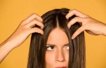 Woman with itchy and irritated scalp