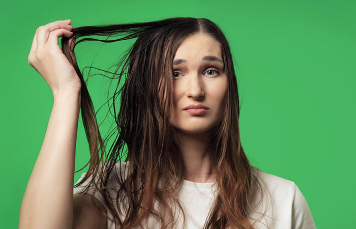 Woman experiencing greasy hair after using sulfate-free shampoo