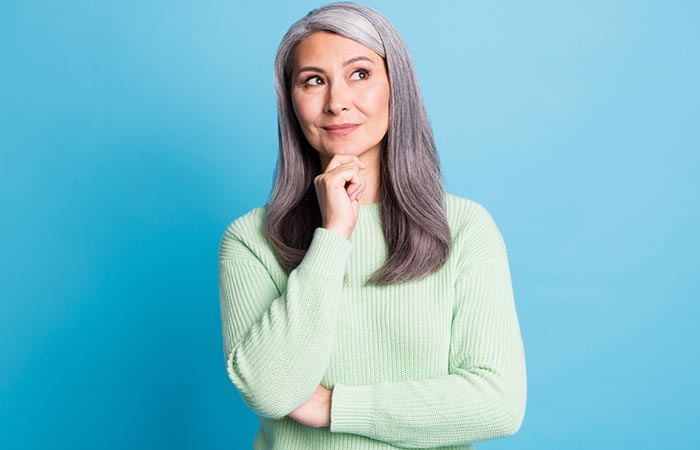 Elderly woman wondering if coconut oil can protect her grey hair 