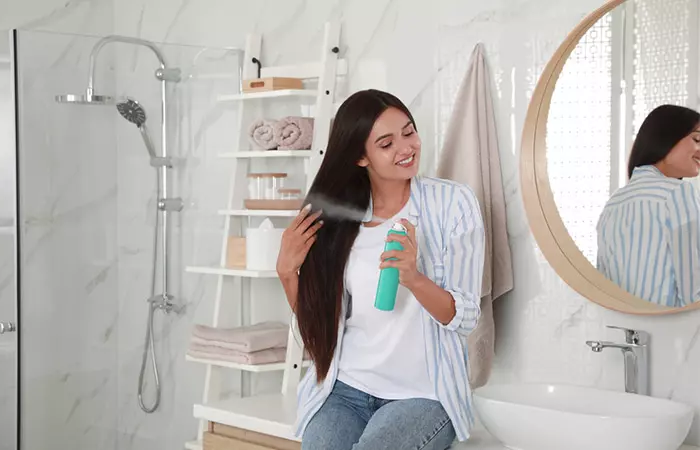 Woman applying dry shampoo