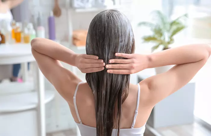 Woman applying keratin hair treatment at home