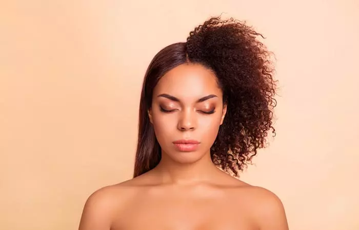 Woman with half straightened and half curly hair during keratin treatment