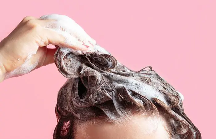 A woman using Horse shampoo on her hair