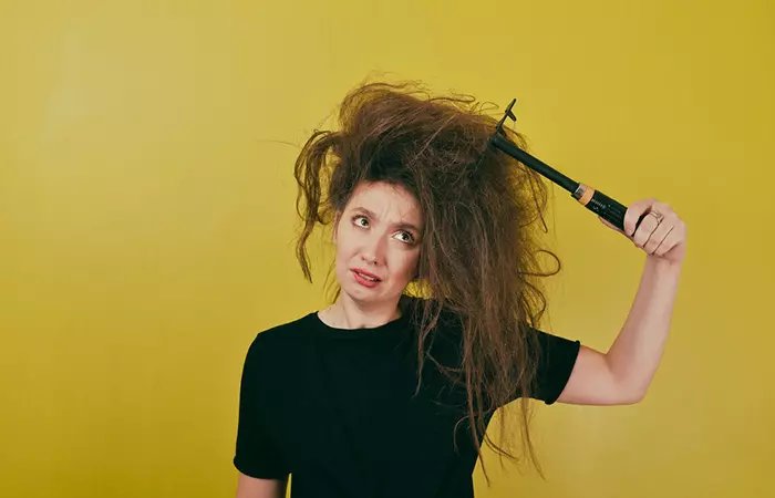 Woman worried about her frizzy hair that resulted from frequent shampooing