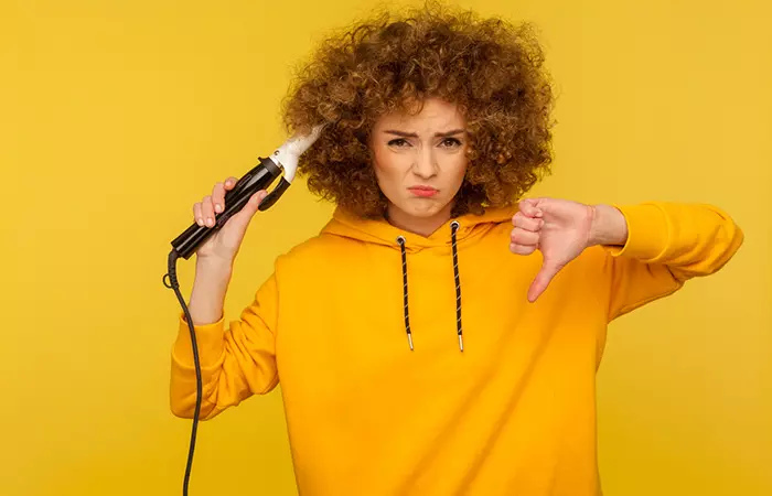 Woman giving thumbs down to heat styling