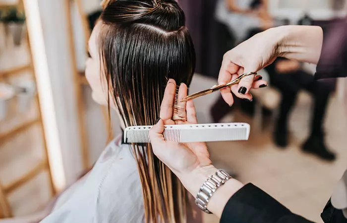 Woman getting her hair cut by a hair dresser