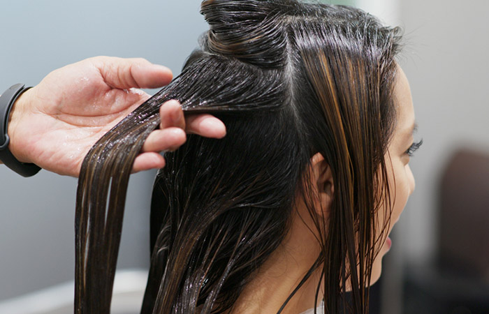 Woman receiving hair treatment at salon