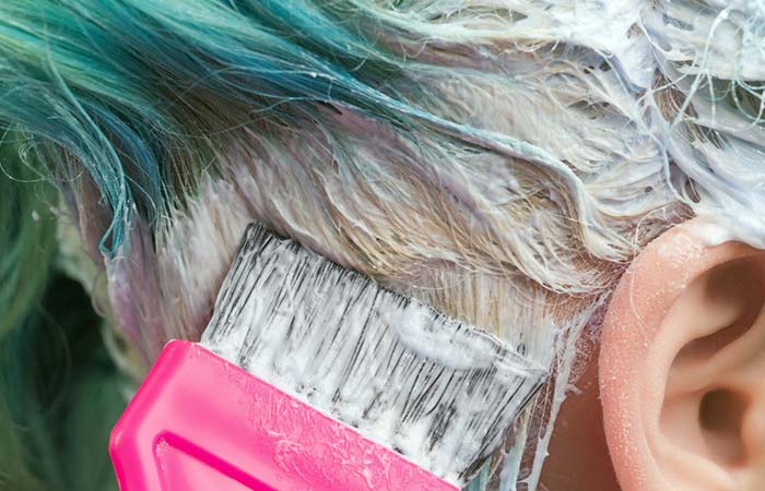Woman getting her green hair bleached