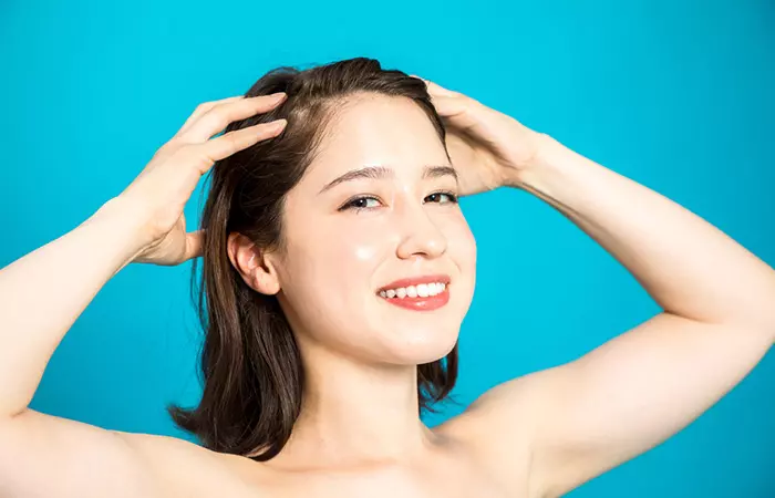 Woman massaging hot oil into her hair