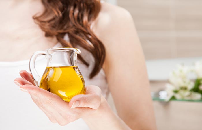 Woman holding a jar of evening primrose oil