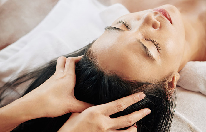 Woman getting a professional scalp massage to increase blood circulation