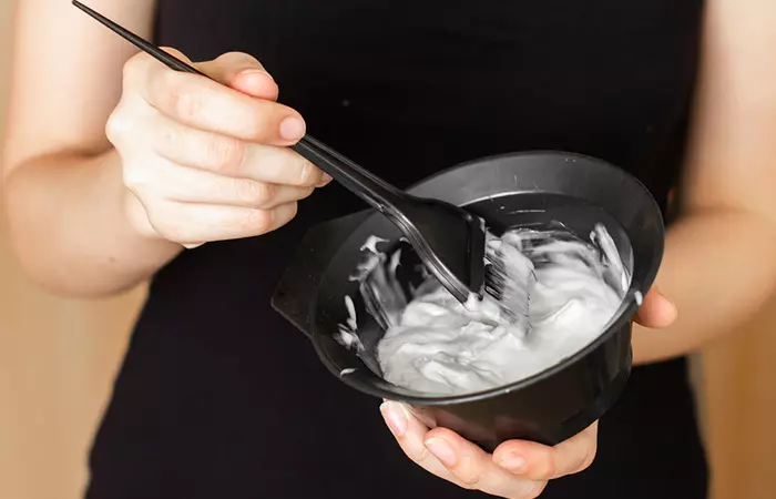 Woman makes a hair dye mix in a bowl