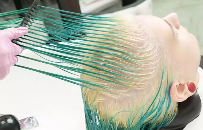 Woman with green hair getting hair treatment done