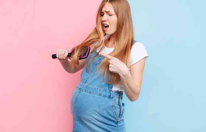 Pregnant woman worried about her fair fall as she holds a hair brush 